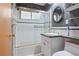 Bathroom with tub/shower combo, vanity, and toilet at 9115 W 5Th Ave, Lakewood, CO 80226