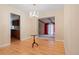 Charming dining room with a view into the kitchen, featuring hardwood floors and a stylish chandelier at 9115 W 5Th Ave, Lakewood, CO 80226