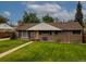 Inviting brick home featuring a lush green lawn and mature trees at 9115 W 5Th Ave, Lakewood, CO 80226