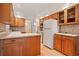 Classic kitchen featuring wooden cabinets, white appliances, and a bright, functional layout at 9115 W 5Th Ave, Lakewood, CO 80226