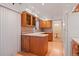 A cozy kitchen with wooden cabinets, white appliances, and a view to the dining area at 9115 W 5Th Ave, Lakewood, CO 80226