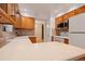 Well-lit kitchen with tile accents, wooden cabinets, and a spacious countertop area at 9115 W 5Th Ave, Lakewood, CO 80226
