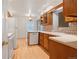 Cozy kitchen with warm wood cabinets, laminate countertops, and tile backsplash at 9115 W 5Th Ave, Lakewood, CO 80226