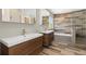 Modern bathroom featuring a double vanity with sleek wood cabinets and tiled shower at 2509 S Bahama Way, Aurora, CO 80013