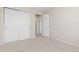 Bedroom with neutral carpet, double closet and white door to the hallway, offering ample storage at 2509 S Bahama Way, Aurora, CO 80013