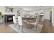 Modern dining area and kitchen with a fireplace and lots of natural light at 2509 S Bahama Way, Aurora, CO 80013
