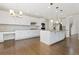 Bright kitchen features white cabinets, stainless steel appliances, and hardwood floors at 2509 S Bahama Way, Aurora, CO 80013