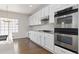 Modern kitchen with stainless steel double oven and gas cooktop at 2509 S Bahama Way, Aurora, CO 80013