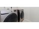 Modern laundry area featuring a side-by-side Samsung washer and dryer set at 2509 S Bahama Way, Aurora, CO 80013