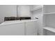 Bright laundry room with classic white washer and dryer with built-in shelving storage at 2509 S Bahama Way, Aurora, CO 80013
