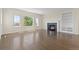 Bright living room with hardwood floors, large windows, a fireplace, and a built-in bookcase at 2509 S Bahama Way, Aurora, CO 80013