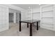 Open living room with neutral colors and table, with bookshelves built in, perfect for entertaining at 2509 S Bahama Way, Aurora, CO 80013