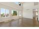 Light-filled living room with hardwood floors, large windows, and views of the neighborhood at 2509 S Bahama Way, Aurora, CO 80013