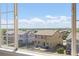 View from a window showing a fenced backyard and neighborhood homes with blue sky in the background at 2509 S Bahama Way, Aurora, CO 80013