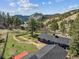 Aerial view of the property showcasing the lush landscape, separate buildings and mountain views at 5384 Olde Stage Rd, Boulder, CO 80302
