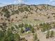 An aerial view showing the home's location and surrounding mountainous, wooded landscape at 5384 Olde Stage Rd, Boulder, CO 80302
