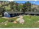 Expansive backyard with lush landscaping, charming bridge, stone pathway, and comfortable outdoor seating at 5384 Olde Stage Rd, Boulder, CO 80302