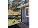 Backyard features a deer near the house and a view of the fenced property line surrounded by trees at 5384 Olde Stage Rd, Boulder, CO 80302