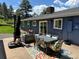 Backyard patio with a dining set and lounge chairs perfect for entertaining or relaxing outdoors at 5384 Olde Stage Rd, Boulder, CO 80302