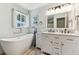 Bathroom featuring soaking tub, double vanity with marble countertop and wood look floors at 5384 Olde Stage Rd, Boulder, CO 80302