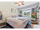 Cozy bedroom with natural light, featuring a ceiling fan, guitar and outdoor views at 5384 Olde Stage Rd, Boulder, CO 80302