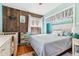 Comfortable bedroom with a crib and wooden wall at 5384 Olde Stage Rd, Boulder, CO 80302