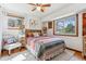 Bright bedroom filled with natural light from the surrounding windows and a colorful boho comforter at 5384 Olde Stage Rd, Boulder, CO 80302
