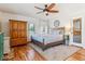 Comfortable bedroom with hardwood floors, ceiling fan, and stylish decor elements at 5384 Olde Stage Rd, Boulder, CO 80302