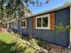 Detailed view of the home's exterior, showing window shutters and the beautiful flower bed at 5384 Olde Stage Rd, Boulder, CO 80302