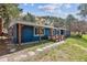 Exterior elevation of a charming blue ranch home with a covered front porch and stone path at 5384 Olde Stage Rd, Boulder, CO 80302