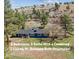 Charming blue ranch home with a covered front porch nestled on a hillside with mature trees at 5384 Olde Stage Rd, Boulder, CO 80302