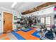 Spacious garage with exposed wood beams, storage for bikes, and blue and orange floor tiles at 5384 Olde Stage Rd, Boulder, CO 80302