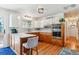 Farmhouse style kitchen featuring wood floors, stainless steel appliances, and breakfast bar seating at 5384 Olde Stage Rd, Boulder, CO 80302