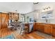 Kitchen and dining room combination featuring stainless steel appliances, wood floors, and sliding barn door at 5384 Olde Stage Rd, Boulder, CO 80302