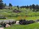Picturesque landscape with a wooden bridge, stone accents, and lush greenery, enhancing the property's charm at 5384 Olde Stage Rd, Boulder, CO 80302