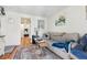 Inviting living room with a comfortable couch, decorative rug, and natural light streaming through the doorway at 5384 Olde Stage Rd, Boulder, CO 80302