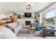 Cozy living room featuring a stone fireplace, modern light fixture, and view of the outdoors at 5384 Olde Stage Rd, Boulder, CO 80302