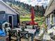 A relaxing outdoor patio area with ample seating, dining area, and views of the lush backyard at 5384 Olde Stage Rd, Boulder, CO 80302