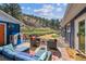 A welcoming outdoor patio with comfortable seating, colorful rug and a view of the surrounding hillside at 5384 Olde Stage Rd, Boulder, CO 80302