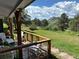 Inviting porch with outdoor seating, offering a serene view of the lush yard and surrounding landscape at 5384 Olde Stage Rd, Boulder, CO 80302