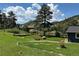 Landscaped backyard featuring vibrant flowers and lush greenery, framed by a classic wooden fence at 5384 Olde Stage Rd, Boulder, CO 80302