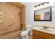 Cozy bathroom with tiled shower and tub combination, updated vanity with lighting and a neutral color palette at 7040 W 20Th Ave # 206, Lakewood, CO 80214