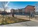 Exterior view of the apartment complex with a well-maintained lawn and fencing at 7040 W 20Th Ave # 206, Lakewood, CO 80214