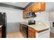 Kitchen featuring granite countertops, stainless appliances, and wooden cabinets at 7040 W 20Th Ave # 206, Lakewood, CO 80214