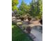 Beautifully landscaped community grounds with vibrant flowers, mature trees, and decorative rock features at 7040 W 20Th Ave # 206, Lakewood, CO 80214