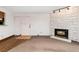 Living room featuring a stone fireplace, tiled entry, and neutral carpet at 7040 W 20Th Ave # 206, Lakewood, CO 80214