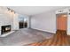 Living room featuring a stone fireplace, sliding glass doors, and gray carpet at 7040 W 20Th Ave # 206, Lakewood, CO 80214