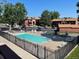 Inviting community pool surrounded by lounge chairs and mature trees near apartment buildings at 7040 W 20Th Ave # 206, Lakewood, CO 80214