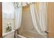 Simple bathroom with shower/tub combo and neutral tile at 6195 Xavier Ct, Arvada, CO 80003