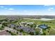 Aerial view of community clubhouse, pool, tennis courts, and adjacent lake at 15802 Xanthia Way, Thornton, CO 80602